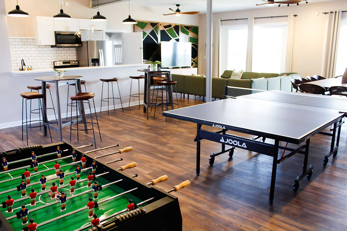 Our standout feature is the spacious entertaining room, complete with a full kitchen, multiple large dining tables, cocktail tables, and a game room.